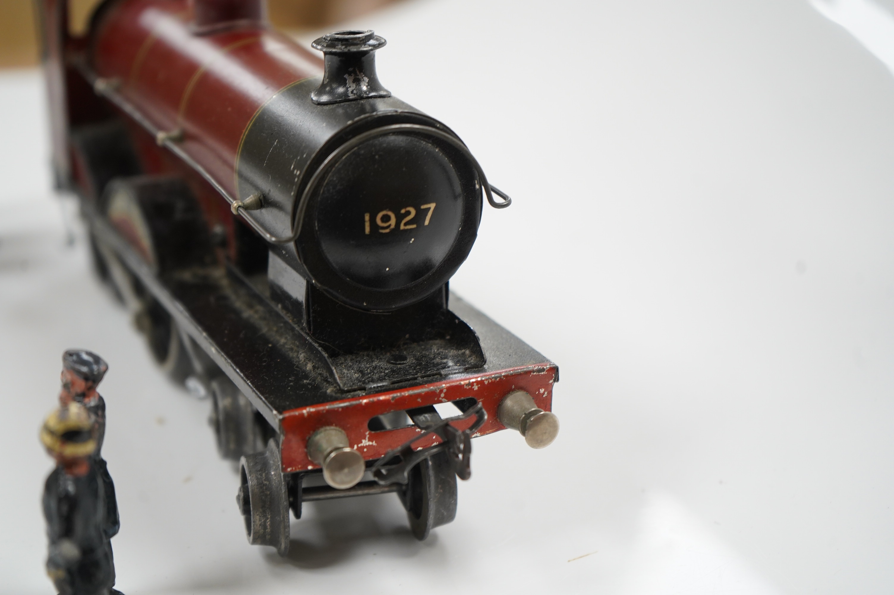 A Bassett Lowke O gauge tinplate clockwork 4-4-0 tender locomotive (missing tender), Duke of York, together with four Crescent/Britains lead railway figures and a milk churn. Condition poor to fair.